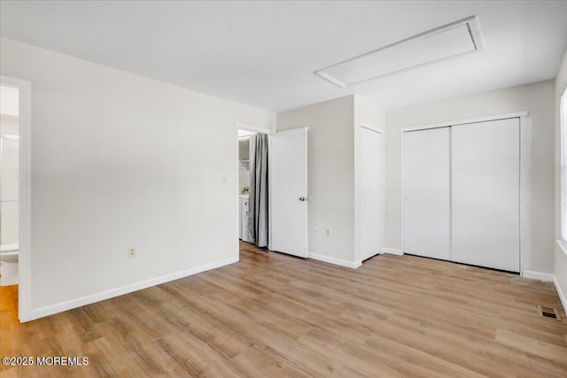 48 Scarborough Ct Unit 7, Freehold, NJ 07728 - unfurnished bedroom with attic access, light wood finished floors, ensuite bath, and baseboards