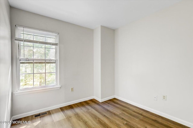 48 Scarborough Ct Unit 7, Freehold, NJ 07728 - empty room with wood finished floors, healthy amount of natural light, and baseboards