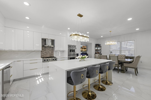 11 Clay St, West Long Branch, NJ 07764 - kitchen with modern cabinets, wall chimney range hood, light marble finish flooring, a chandelier, and appliances with stainless steel finishes