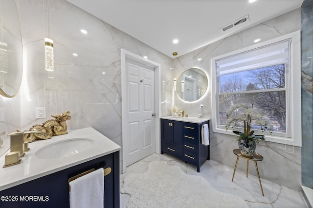 11 Clay St, West Long Branch, NJ 07764 - full bathroom featuring marble tiled flooring, two vanities, recessed lighting, and tile walls