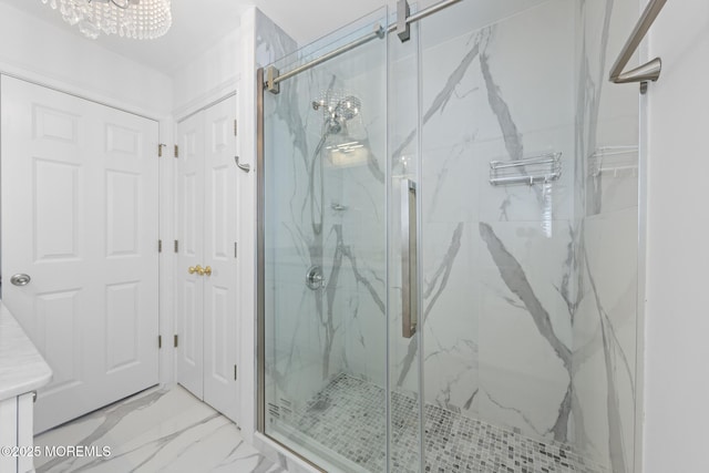 11 Clay St, West Long Branch, NJ 07764 - bathroom featuring marble finish flooring, a marble finish shower, a chandelier, and vanity