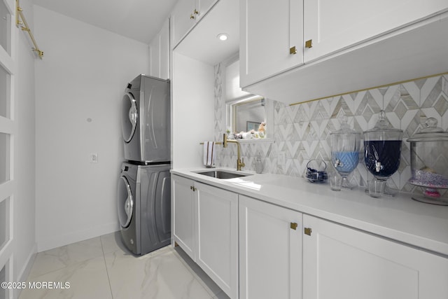 11 Clay St, West Long Branch, NJ 07764 - washroom with stacked washer / drying machine, cabinet space, light marble finish flooring, and baseboards