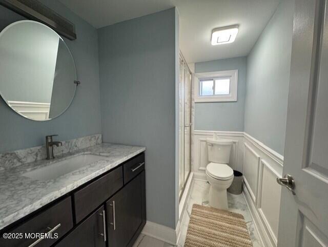 13 John St, Hazlet, NJ 07730 - bathroom with toilet, a stall shower, vanity, a decorative wall, and a wainscoted wall