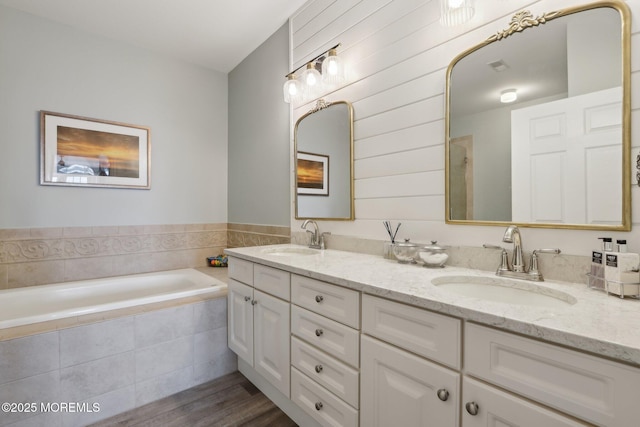 33 Cooper Ave Unit 401, Long Branch, NJ 07740 - bathroom with double vanity, a bath, and wood finished floors