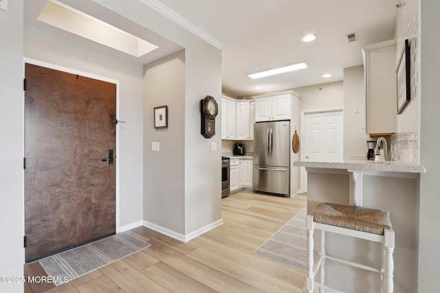 33 Cooper Ave Unit 401, Long Branch, NJ 07740 - kitchen featuring stainless steel appliances, light wood-style flooring, white cabinets, baseboards, and recessed lighting