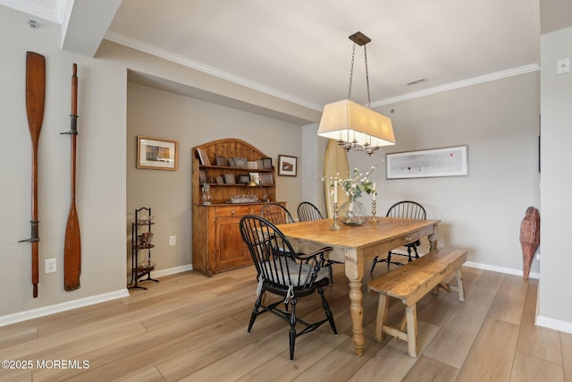 33 Cooper Ave Unit 401, Long Branch, NJ 07740 - dining space featuring light wood-type flooring, ornamental molding, a chandelier, and baseboards
