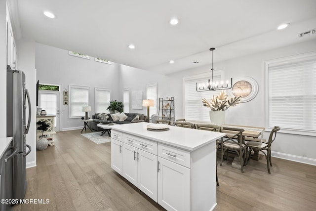 115 Hedgerow Ln, Manalapan, NJ 07726 - kitchen featuring freestanding refrigerator, light wood-style flooring, white cabinetry, light countertops, and recessed lighting