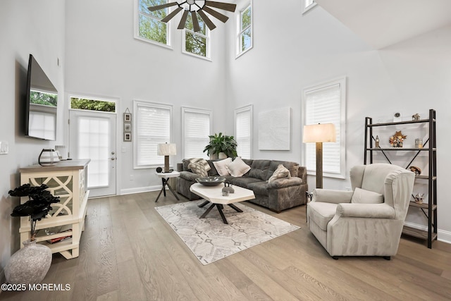 115 Hedgerow Ln, Manalapan, NJ 07726 - living room with a ceiling fan, a high ceiling, wood finished floors, and baseboards