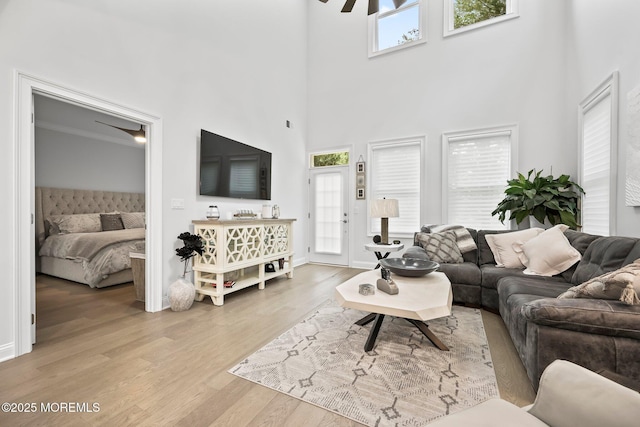 115 Hedgerow Ln, Manalapan, NJ 07726 - living area featuring wood finished floors, a high ceiling, and baseboards