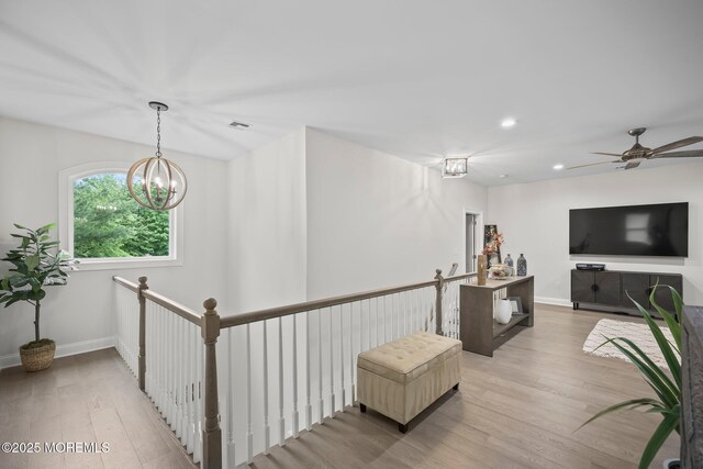 115 Hedgerow Ln, Manalapan, NJ 07726 - corridor featuring an upstairs landing, light wood-style flooring, recessed lighting, a chandelier, and baseboards