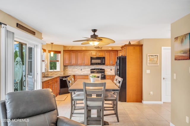 1007 Aloha Dr, Forked River, NJ 08731 - kitchen with black appliances, tasteful backsplash, a sink, a ceiling fan, and light tile patterned floors