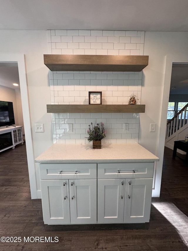 63 1st St, Barnegat, NJ 08005 - bar area with backsplash, dark wood-type flooring, stairway, and baseboards