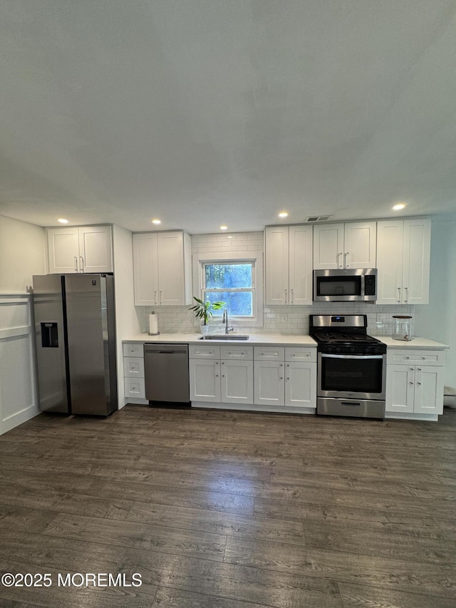 63 1st St, Barnegat, NJ 08005 - kitchen featuring stainless steel appliances, a sink, backsplash, dark wood finished floors, and recessed lighting