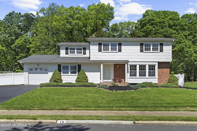10 Pepperidge Rd, Howell, NJ 07731 - view of front of property featuring a garage, asphalt driveway, and brick siding