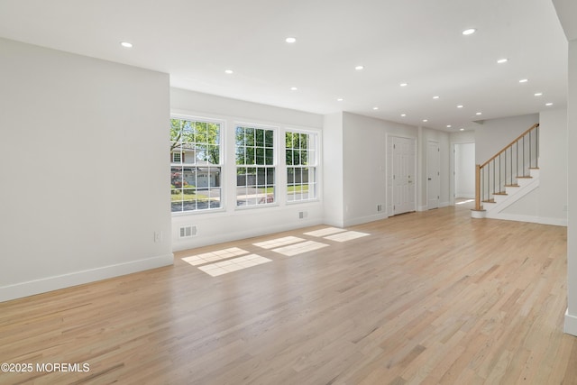 10 Pepperidge Rd, Howell, NJ 07731 - unfurnished living room with light wood-style flooring, recessed lighting, baseboards, and stairs