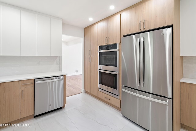 10 Pepperidge Rd, Howell, NJ 07731 - kitchen featuring stainless steel appliances, tasteful backsplash, light countertops, recessed lighting, and light marble finish flooring