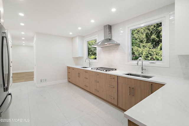 10 Pepperidge Rd, Howell, NJ 07731 - kitchen with wall chimney range hood, a sink, appliances with stainless steel finishes, tasteful backsplash, and recessed lighting