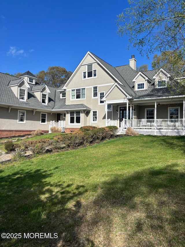 231 Friendship Rd, Howell, NJ 07731 - view of front of home featuring covered porch, a front yard, and a chimney