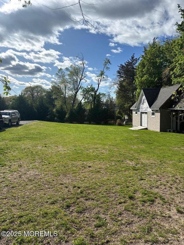 231 Friendship Rd, Howell, NJ 07731 - view of grassy yard with an outdoor structure and a garage