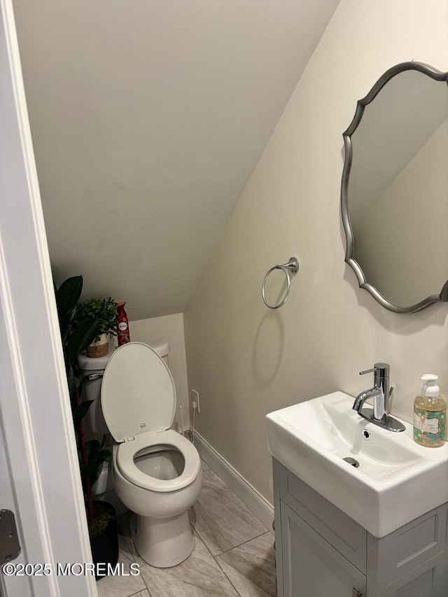 231 Friendship Rd, Howell, NJ 07731 - bathroom featuring vanity, lofted ceiling, baseboards, and toilet