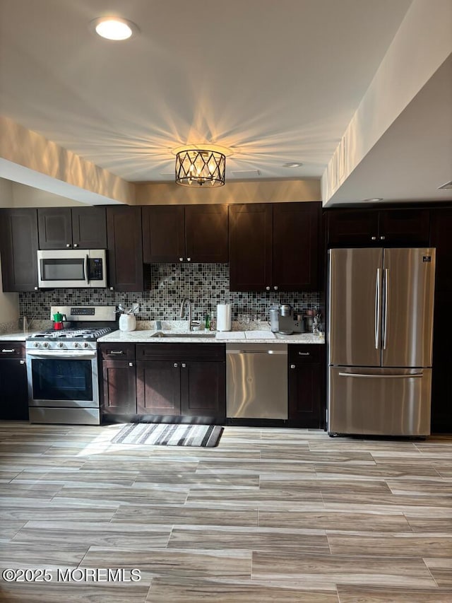 231 Friendship Rd, Howell, NJ 07731 - kitchen with appliances with stainless steel finishes, a sink, backsplash, dark brown cabinets, and recessed lighting
