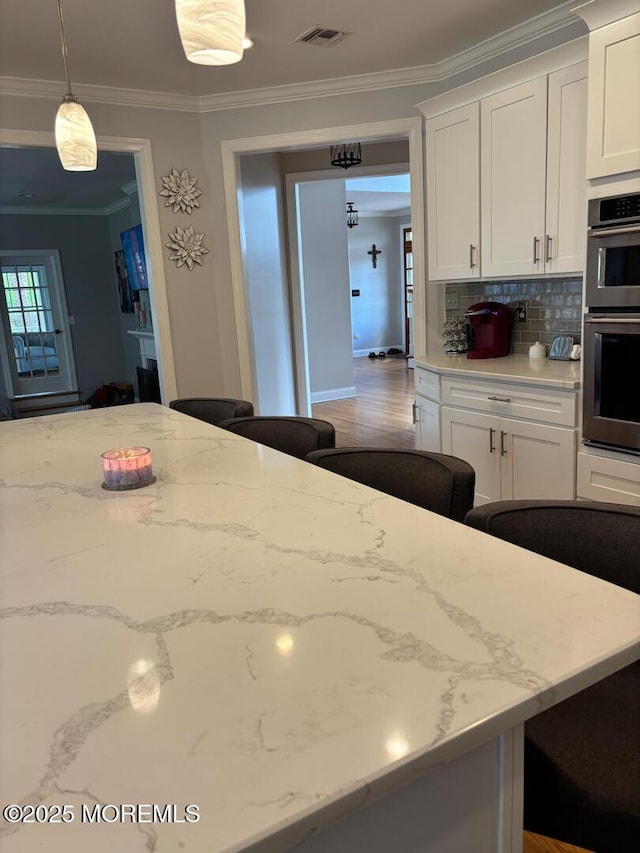 231 Friendship Rd, Howell, NJ 07731 - kitchen featuring crown molding, white cabinets, double wall oven, backsplash, and plenty of natural light