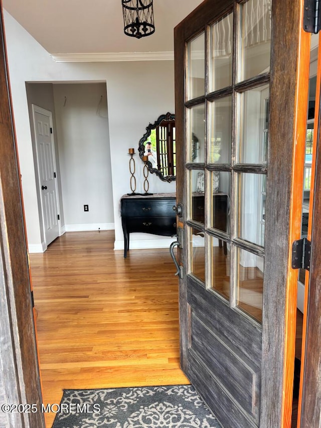 231 Friendship Rd, Howell, NJ 07731 - hallway featuring baseboards, wood finished floors, crown molding, and a chandelier