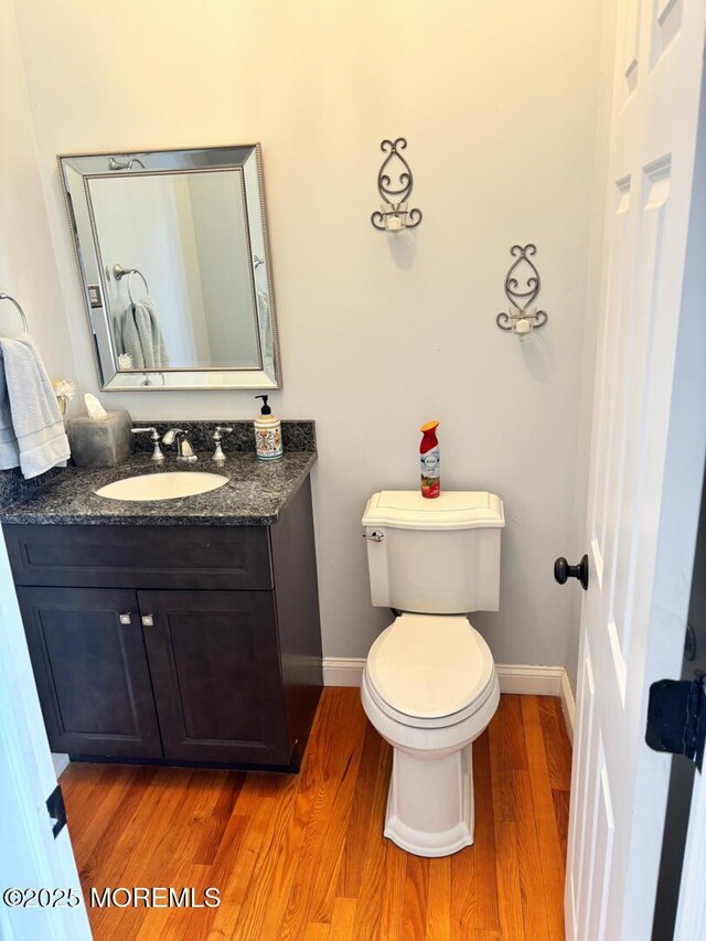 231 Friendship Rd, Howell, NJ 07731 - bathroom featuring wood finished floors, baseboards, vanity, and toilet