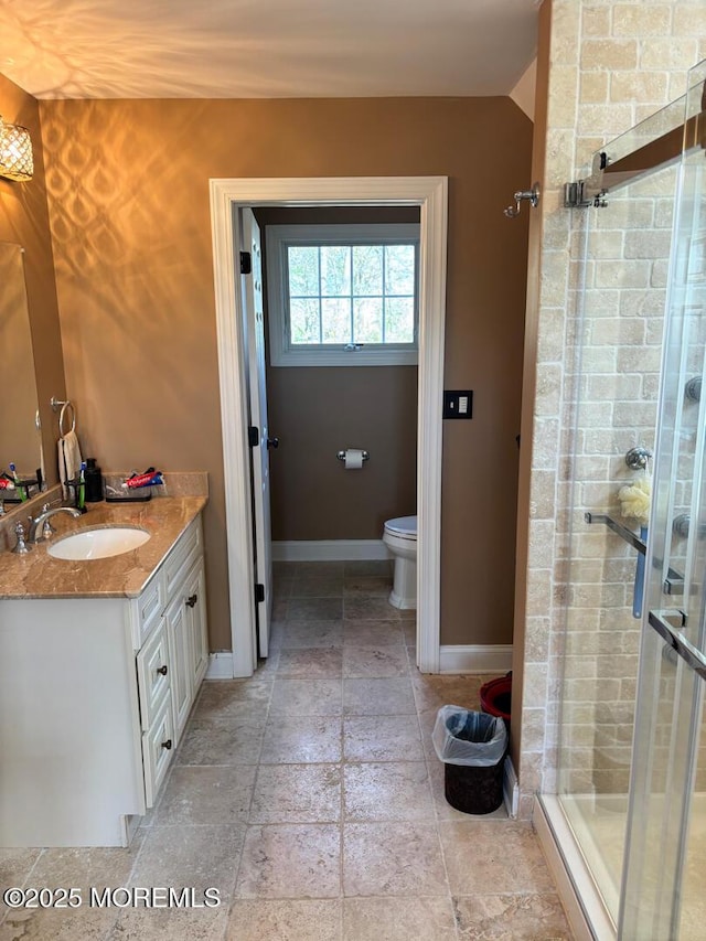 231 Friendship Rd, Howell, NJ 07731 - bathroom with baseboards, a stall shower, stone tile flooring, toilet, and vanity