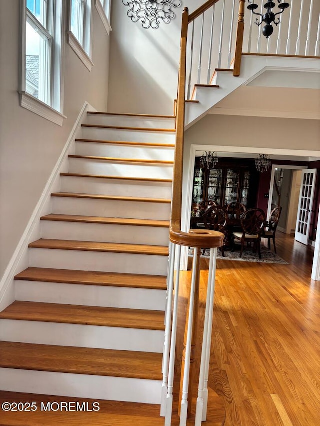 231 Friendship Rd, Howell, NJ 07731 - stairway with a chandelier, a high ceiling, and wood finished floors