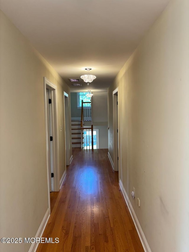 231 Friendship Rd, Howell, NJ 07731 - hall featuring wood finished floors, baseboards, and a chandelier