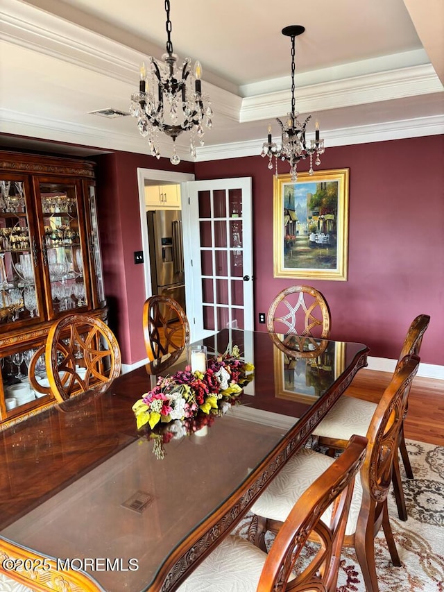 231 Friendship Rd, Howell, NJ 07731 - dining room featuring a chandelier, baseboards, a tray ceiling, crown molding, and wood finished floors