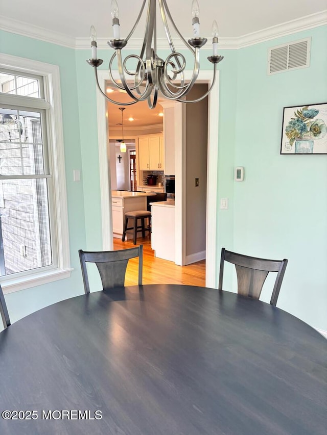 231 Friendship Rd, Howell, NJ 07731 - unfurnished dining area with a chandelier, crown molding, and light wood-type flooring