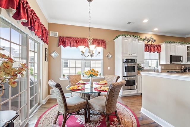 83 Brigantine Blvd, Waretown, NJ 08758 - dining area with a chandelier, healthy amount of natural light, crown molding, light wood finished floors, and recessed lighting