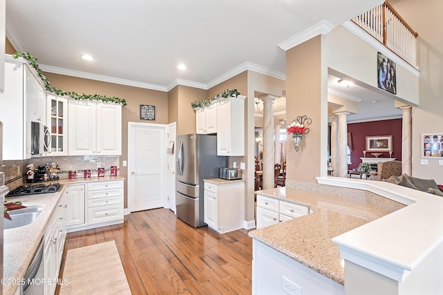 83 Brigantine Blvd, Waretown, NJ 08758 - kitchen featuring decorative columns, appliances with stainless steel finishes, light wood-style flooring, crown molding, and white cabinets