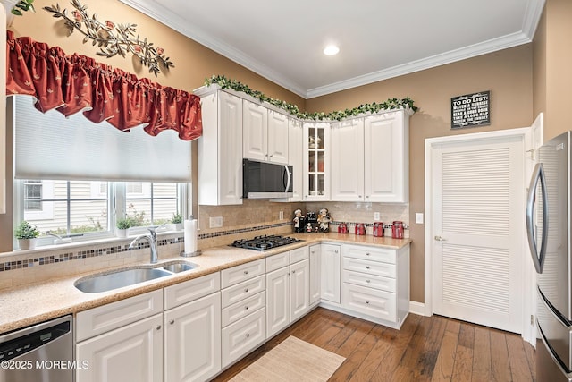 83 Brigantine Blvd, Waretown, NJ 08758 - kitchen featuring stainless steel appliances, a sink, crown molding, backsplash, and glass insert cabinets
