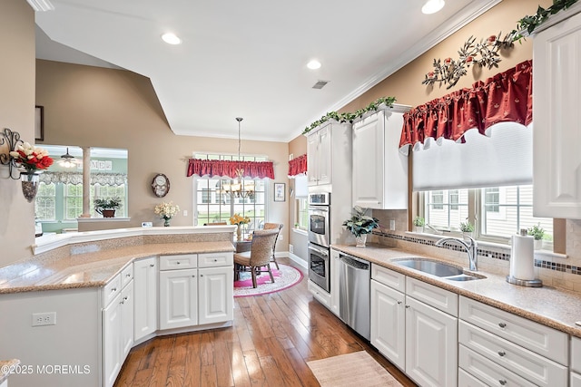 83 Brigantine Blvd, Waretown, NJ 08758 - kitchen with stainless steel appliances, a sink, white cabinetry, crown molding, and recessed lighting