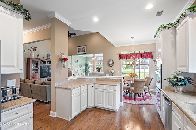 83 Brigantine Blvd, Waretown, NJ 08758 - kitchen with stainless steel appliances, wood-type flooring, white cabinets, ornamental molding, and decorative light fixtures
