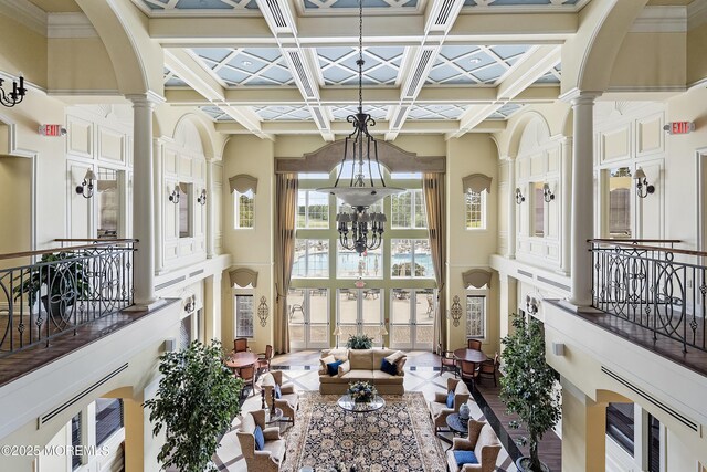 83 Brigantine Blvd, Waretown, NJ 08758 - dining area with a chandelier, a high ceiling, decorative columns, coffered ceiling, and beamed ceiling