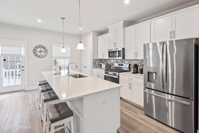 1915 Switzer Ave Unit 1915, Parlin, NJ 08859 - kitchen featuring stainless steel appliances, a sink, tasteful backsplash, a kitchen breakfast bar, and an island with sink