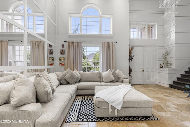 17 Meadow Run Ct, Jackson, NJ 08527 - living area featuring a high ceiling, stone tile flooring, and stairway