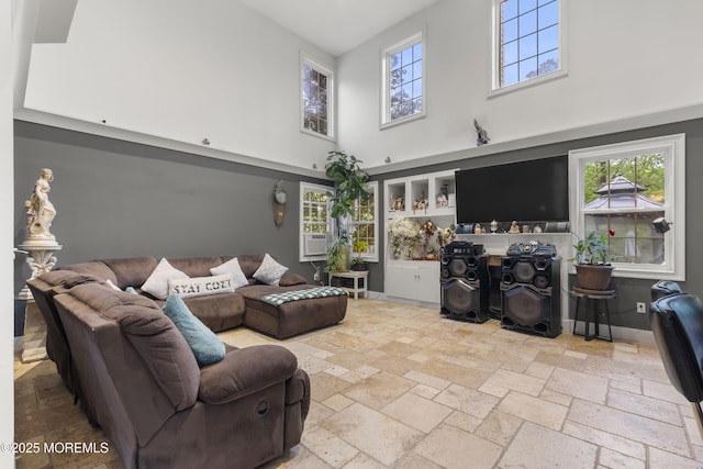 17 Meadow Run Ct, Jackson, NJ 08527 - living area featuring a towering ceiling, stone tile floors, and healthy amount of natural light