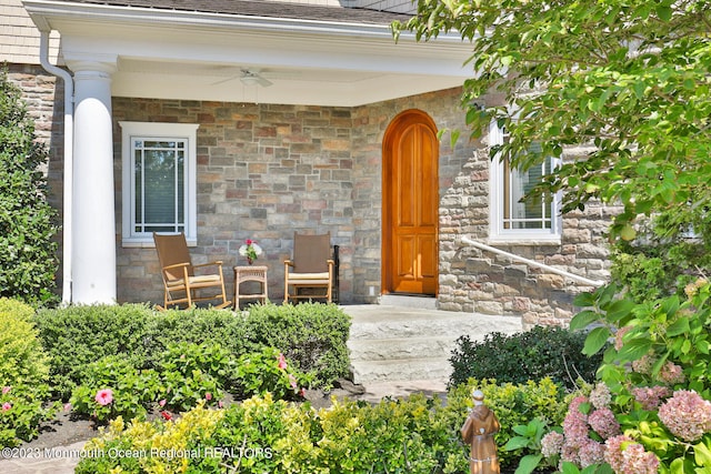211 Cedar Ave, Long Branch, NJ 07740 - property entrance featuring stone siding, ceiling fan, and a shingled roof