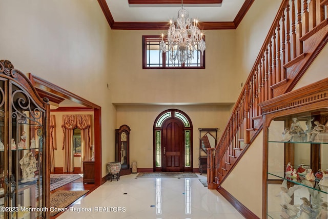 211 Cedar Ave, Long Branch, NJ 07740 - entrance foyer with a chandelier, stairway, baseboards, crown molding, and a towering ceiling