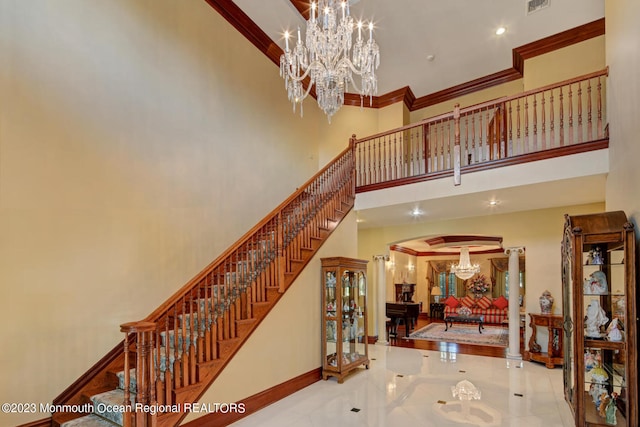 211 Cedar Ave, Long Branch, NJ 07740 - stairway with a towering ceiling, arched walkways, a chandelier, baseboards, and ornamental molding