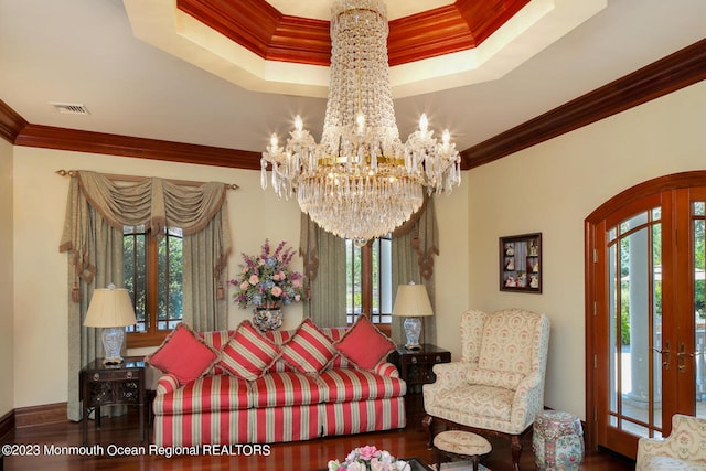 211 Cedar Ave, Long Branch, NJ 07740 - living room with ornamental molding, arched walkways, wood finished floors, a chandelier, and a tray ceiling