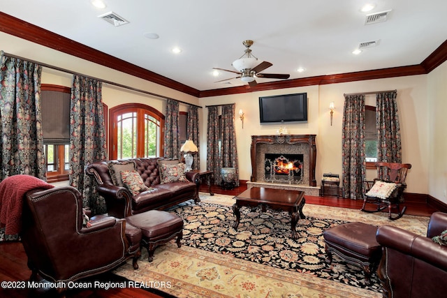 211 Cedar Ave, Long Branch, NJ 07740 - living area with ceiling fan, ornamental molding, a high end fireplace, wood finished floors, and baseboards