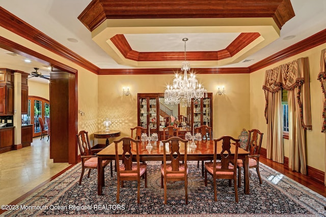 211 Cedar Ave, Long Branch, NJ 07740 - dining space with crown molding, a chandelier, a raised ceiling, ceiling fan, and baseboards