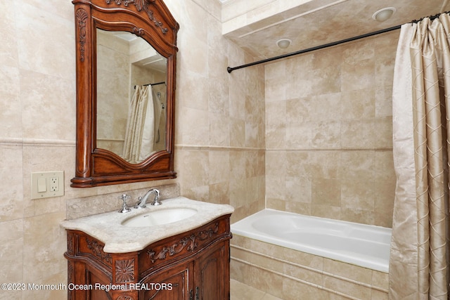 211 Cedar Ave, Long Branch, NJ 07740 - full bathroom featuring tile walls, vanity, and tiled shower / bath