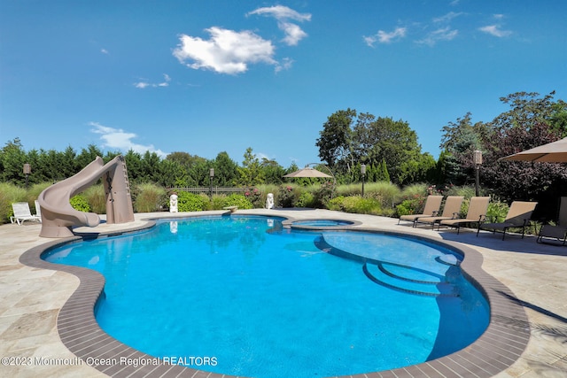 211 Cedar Ave, Long Branch, NJ 07740 - swimming pool with a water slide, a patio area, and an in-ground hot tub